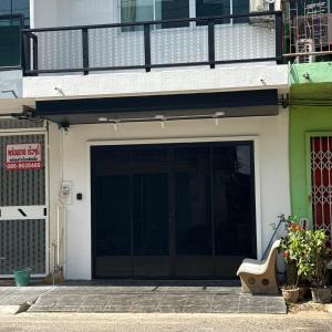 a building with a large garage with a balcony at O Pha Suk House in Hat Yai