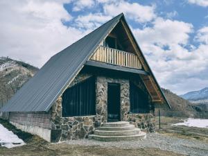 a cabin in the mountains with a gambrel roof at Kedari Borjomi Cottage in Borjomi