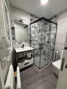 a bathroom with a shower and a sink at Hostal Los Rosales in Tejeda de Tiétar +22 photos