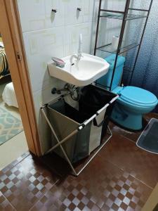 a bathroom with a sink and a toilet at Camigs Vacation House in Mambajao