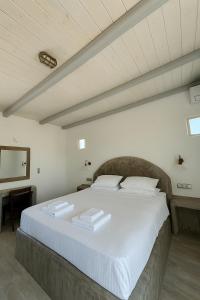 a bedroom with a large bed with white sheets at My Villa Naxos in Naxos Chora +142 photos