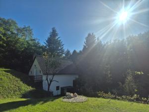 a house on a hill with the sun in the sky at Várhegy apartman in Neszmély