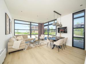 a living room with a couch and a table at Villa Meerzicht | 6 Pers. in Workum