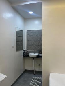 a bathroom with a sink and a mirror at Hotel Tulsi in Aurangabad
