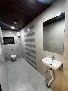 a bathroom with a sink and a toilet at Hotel Tulsi in Aurangabad