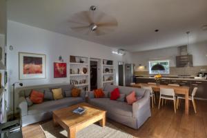 a living room with a couch and a table at CAN COLL DES COCONS BAREFOOT HOUSE 5MIN FROM PACHA in Ibiza Town