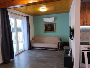 a living room with a couch and a window at Little Village Loft in Káty