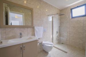 a bathroom with a toilet and a sink and a shower at VillA Esin in Kaş +22 photos