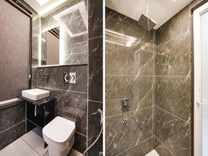 a bathroom with a toilet and a shower at Hotel Asian Near Delhi Airport in New Delhi +17 photos