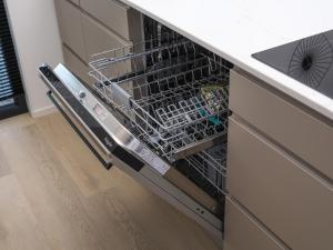 a dishwasher with the door open in a kitchen at Villa L-Meerzicht | 4 pers. in Workum