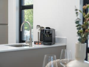 a appliance sitting on a kitchen counter next to a sink at Villa L-Meerzicht | 4 pers. in Workum
