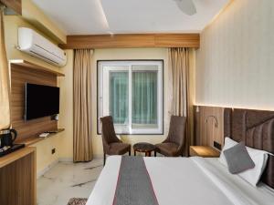 a hotel room with a bed and a window at Hotel Asian Near Delhi Airport in New Delhi