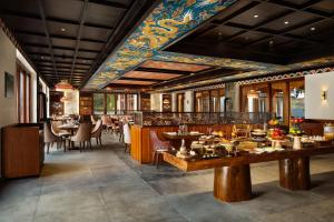 a restaurant with tables and chairs in a room at Taj Paro Resort & Spa in Paro