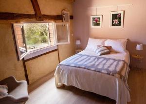 a bedroom with a large bed and a window at L'Esprit du 24 in Rouffignac-de-Sigoulès