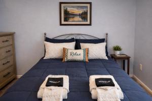 a bedroom with a blue bed with towels on it at The Williamsburg Haven in Williamsburg