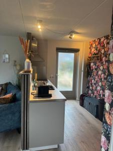 a kitchen and a living room with a counter top at Hubanet in Giethoorn
