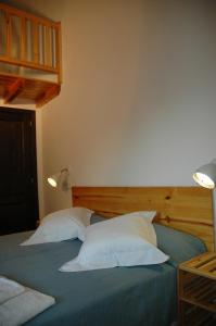 a bedroom with a bed with two pillows at La Sabina in Montsonis