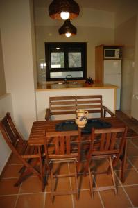 a kitchen with a wooden table and four chairs at Casa con vistas al valle in Montsonis