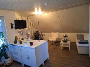 a living room with a table and a couch and a tv at Dixi-Land in Tauche