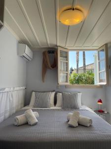a bedroom with a large bed with two pillows at Vivi's Apartments Loft in Spetses