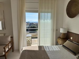a bedroom with a bed and a window with a view at casa santa caterina in Torroella de Montgrí +47 photos