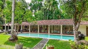 an image of a resort with a swimming pool at Heenatigala Walawwa - Free Shuttle to Our Private Beach in Talpe