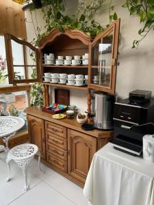 a kitchen with a table and a counter with a mirror at Hotelik Zielonka in Zielonka