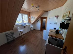 an attic room with a kitchen and a living room at Dixi-Land in Tauche