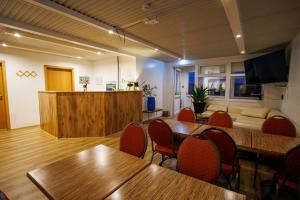 a conference room with tables and chairs and a couch at Malarhorn Accommodations in Drangsnes