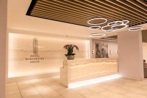 a lobby of a hotel with a wall with a flower vase at Bracknell Stylish Two Bedroom Apartment in Bracknell