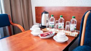 a table with bottles of alcohol and a kettle on it at Zajazd Przy Granicy in Słuczanka