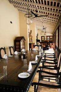 a dining room with a long table and chairs at Heenatigala Walawwa - Free Shuttle to Our Private Beach in Talpe