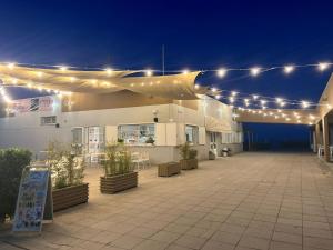 a rooftop patio with lights and tables and chairs at Villa Cavour in Comacchio