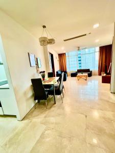 a dining room and living room with a table and chairs at Apartment klcc area in Kuala Lumpur