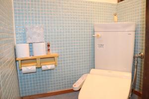 a small blue tiled bathroom with a white toilet at 名古屋駅 中部国際空港近くの宿ひろし in Nagoya +49 photos