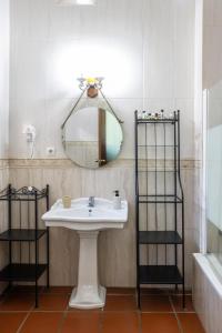 a bathroom with a sink and a mirror at La Posada de Zepeda in Jerez de la Frontera