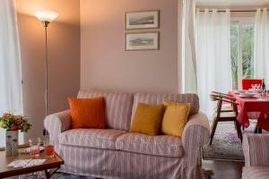 a living room with a couch with colorful pillows at Villa Ametista in Meina +11 photos
