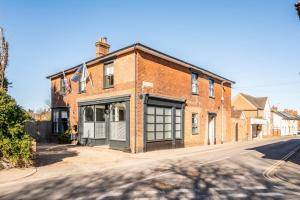 an old brick building on the side of a street at The Leiston, High Street in Leiston
