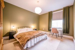 a bedroom with a large bed and a window at The Leiston, High Street in Leiston