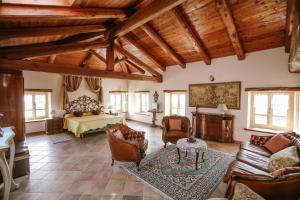 a living room with a bed and a couch and chairs at La Casa di Alice in Villa San Secondo