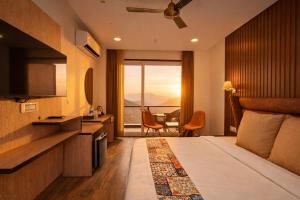 a hotel room with a bed and a large window at AH Grand Villa - Hotel Near Dalai Lama Temple in McLeod Ganj