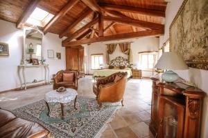 a living room with a bed and a table at La Casa di Alice in Villa San Secondo