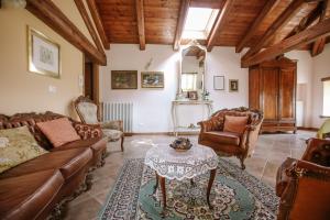 a living room with a couch and chairs and a table at La Casa di Alice in Villa San Secondo
