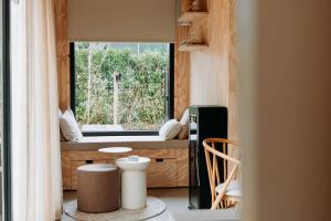 a room with a window and a table and chairs at Knus gezinsverblijf in Cosi Tiny House op de Veluwe in Epe