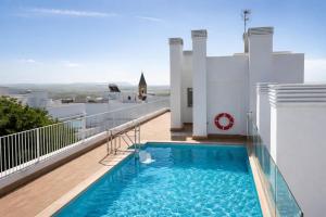 a swimming pool on the balcony of a house at NUEVO-LUZ DE CONIL piscina y parking in Conil de la Frontera