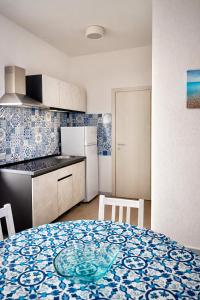 a kitchen with a table with a plate on it at Aeolian Apartments in Lipari