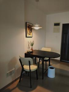 a dining room with a black table and chairs at Chihiro Haven in Chongqing