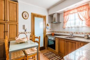 a kitchen with a table and a sink and a counter at Near beach and Oporto in Vila Nova de Gaia