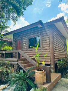 a tiny house with a porch and plants in front of it at Mireya Resort Khaoyai in Ban Khanong Phra Nua