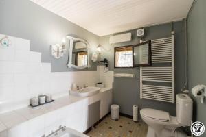 a bathroom with a sink and a toilet at L'atelier du huchier in Poucharramet +40 photos